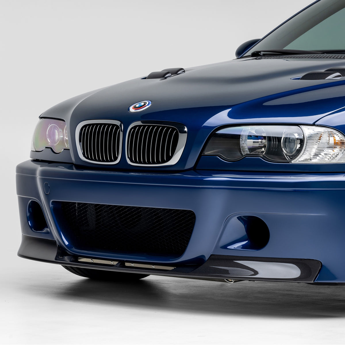 Vorsteiner Aerodynamics V20 carbon fiber front splitter for 2000-2006 BMW E46 M3, glossy 1-piece aero upgrade.