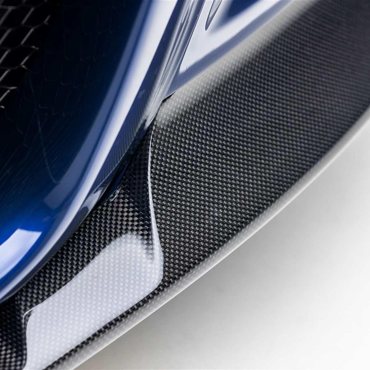 Vorsteiner Aero V20 carbon fiber front splitter for BMW E46 M3 2000-2006, glossy 1-piece design enhancing aerodynamics and style.