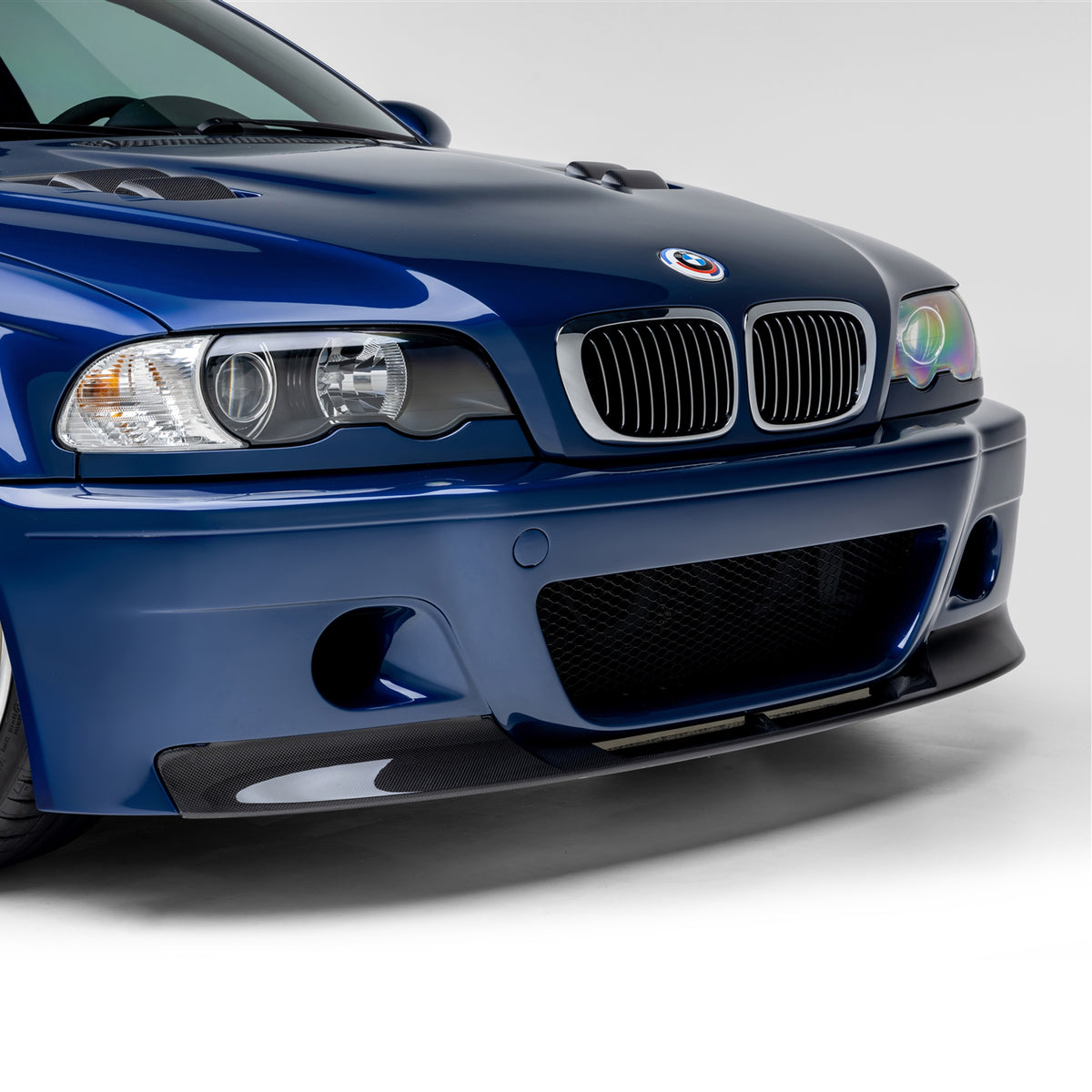 BMW E46 M3 V20 carbon fiber front splitter by Vorsteiner Aero, glossy 1-piece design, enhances aerodynamic performance.