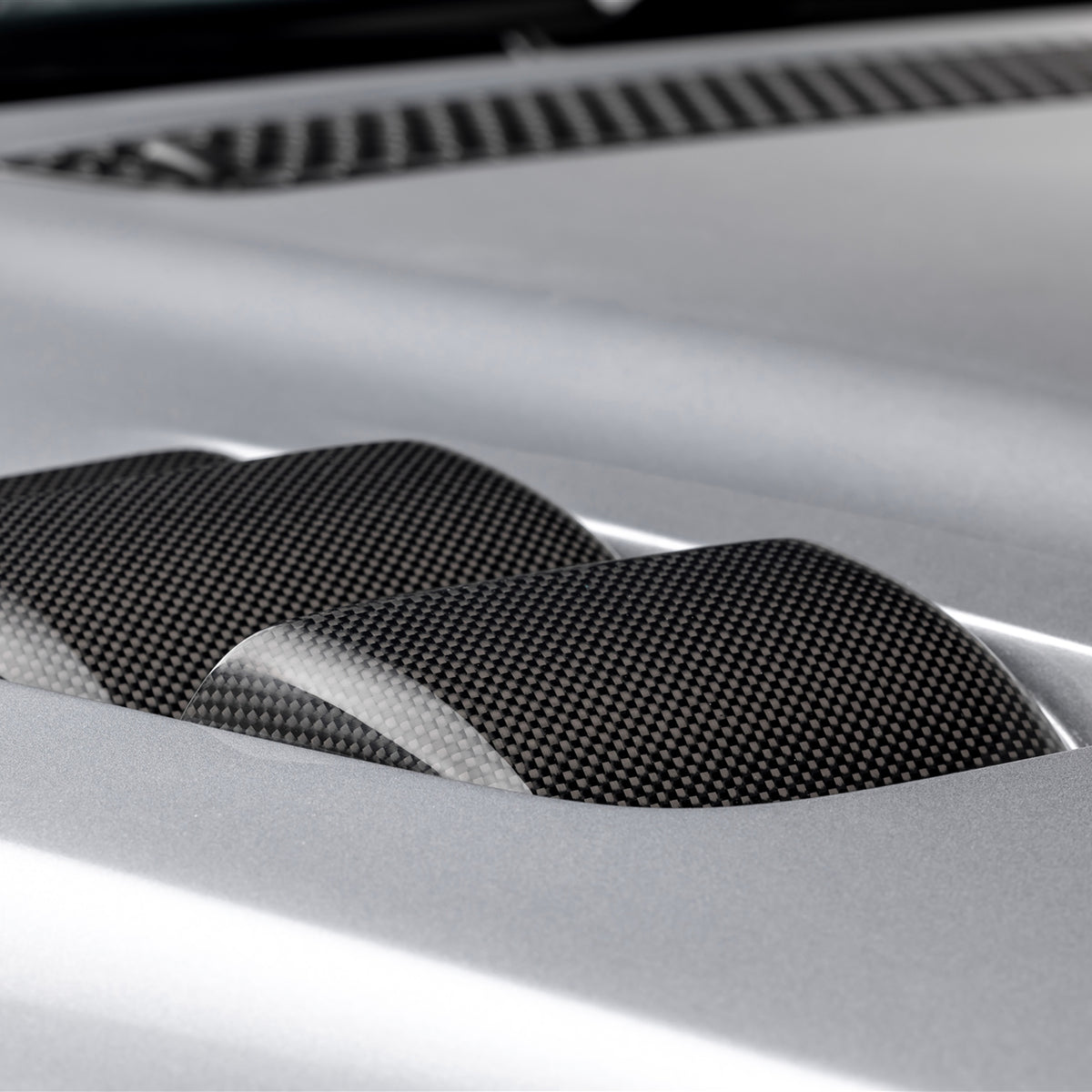 BMW E46 M3 V20 Aero carbon fiber vented hood by Vorsteiner, glossy 1x1 weave, showcasing its sleek aerodynamic design.