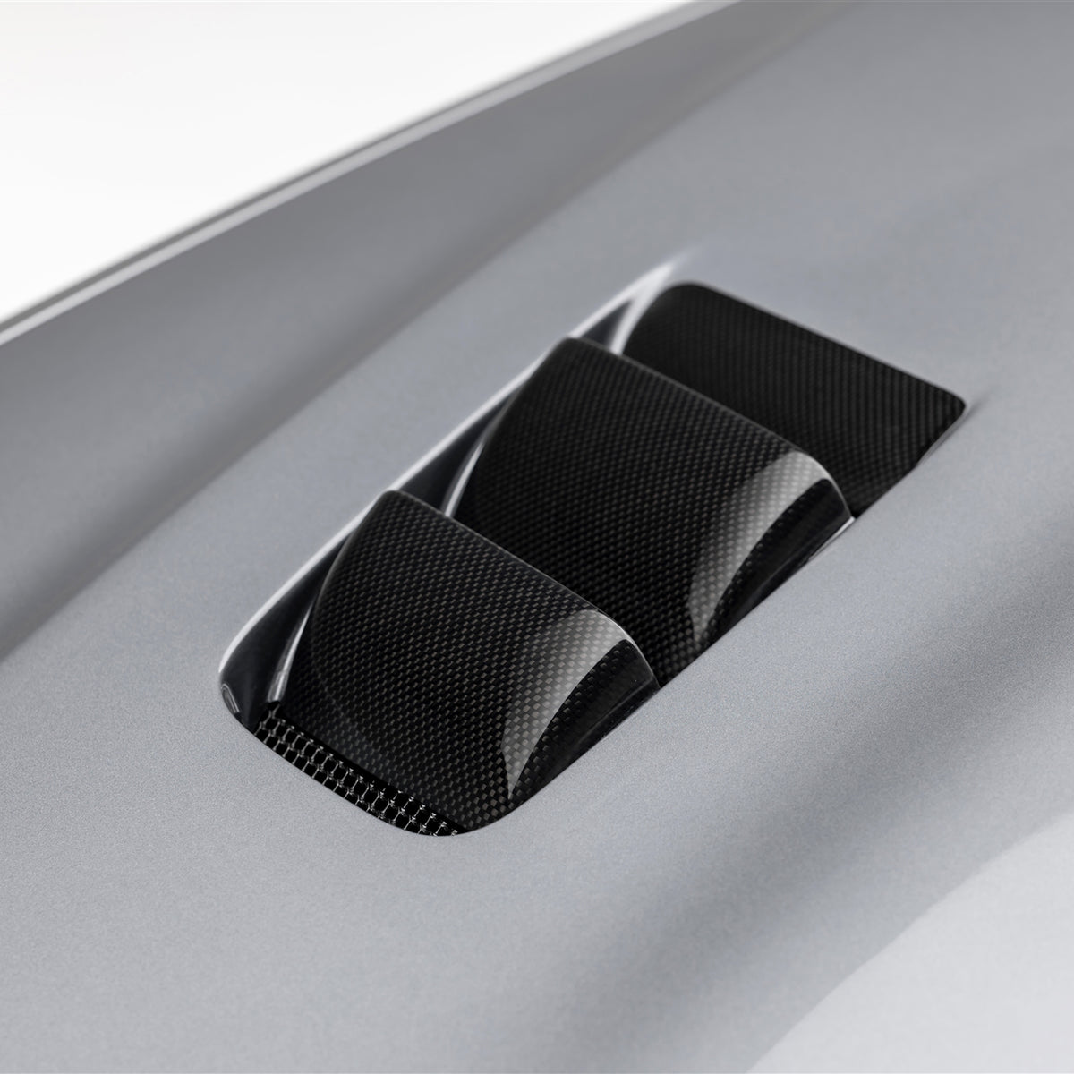 BMW E46 M3 V20 carbon fiber vented hood by Vorsteiner Aero, glossy finish, showcasing the lightweight aerodynamic design.