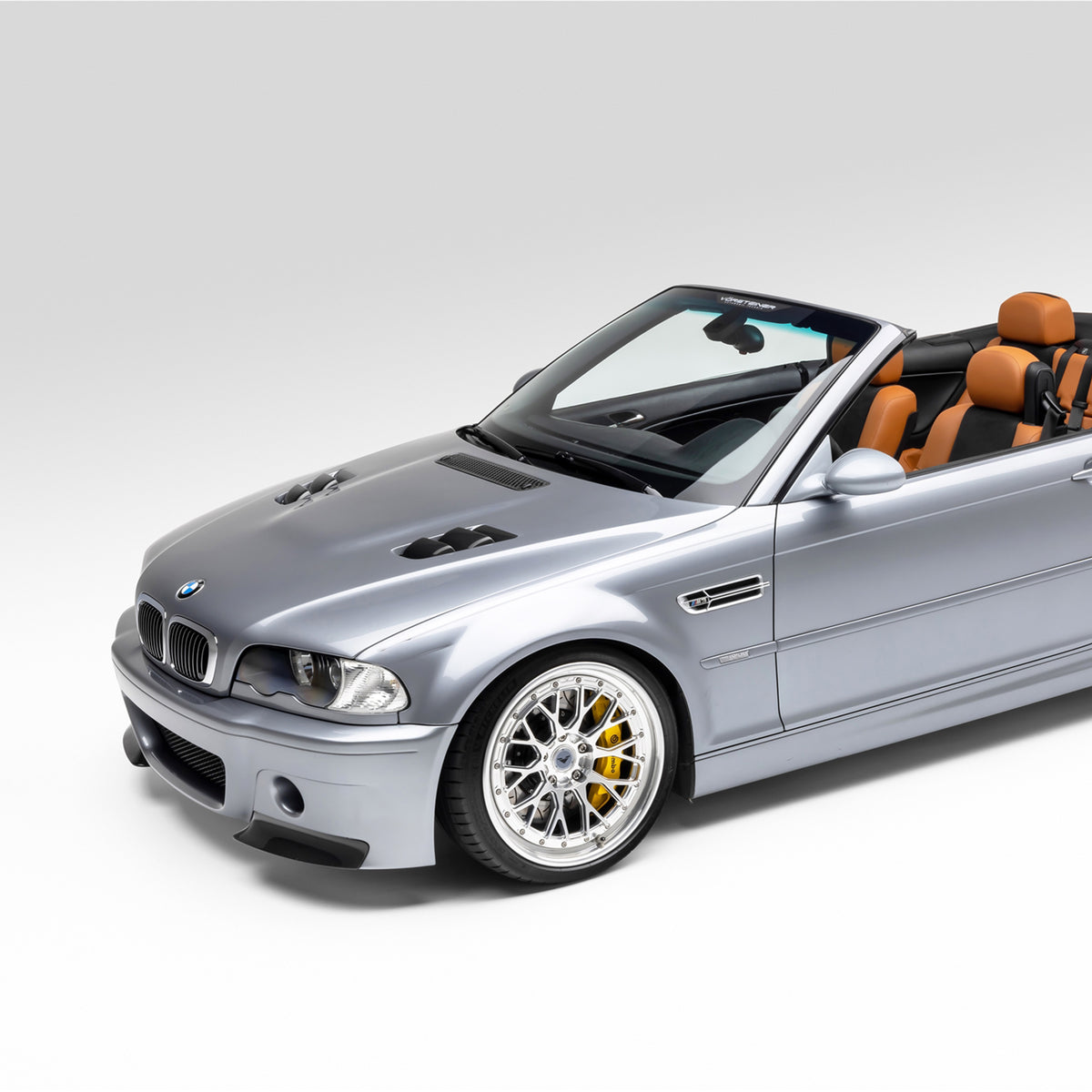 BMW E46 M3 V20 carbon fiber vented hood by Vorsteiner Aero, glossy finish, showcasing the lightweight, aerodynamic design.