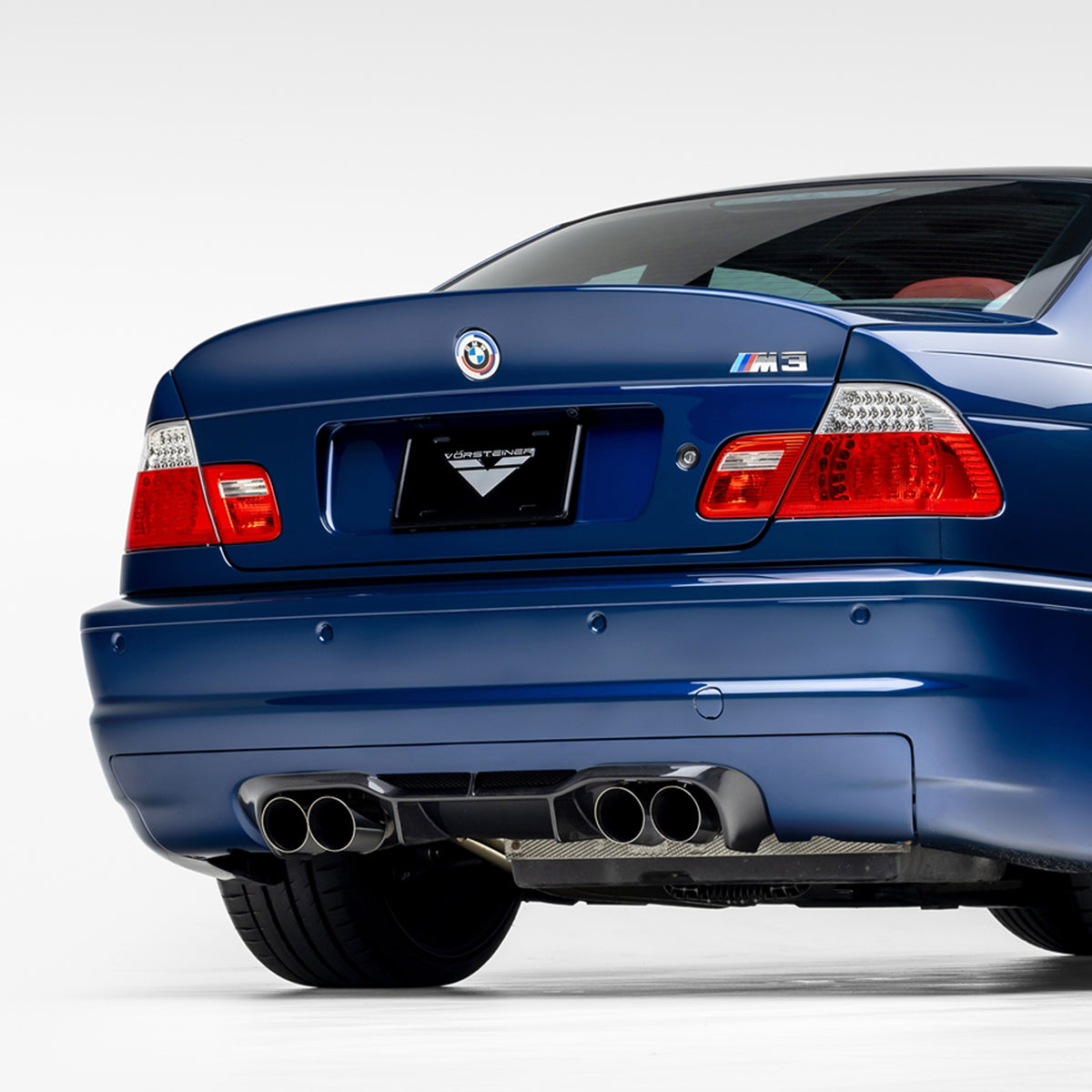 BMW E46 M3 V20 carbon fiber rear diffuser by Vorsteiner Aero, glossy 1x1 weave, designed for 2000-2006 model.