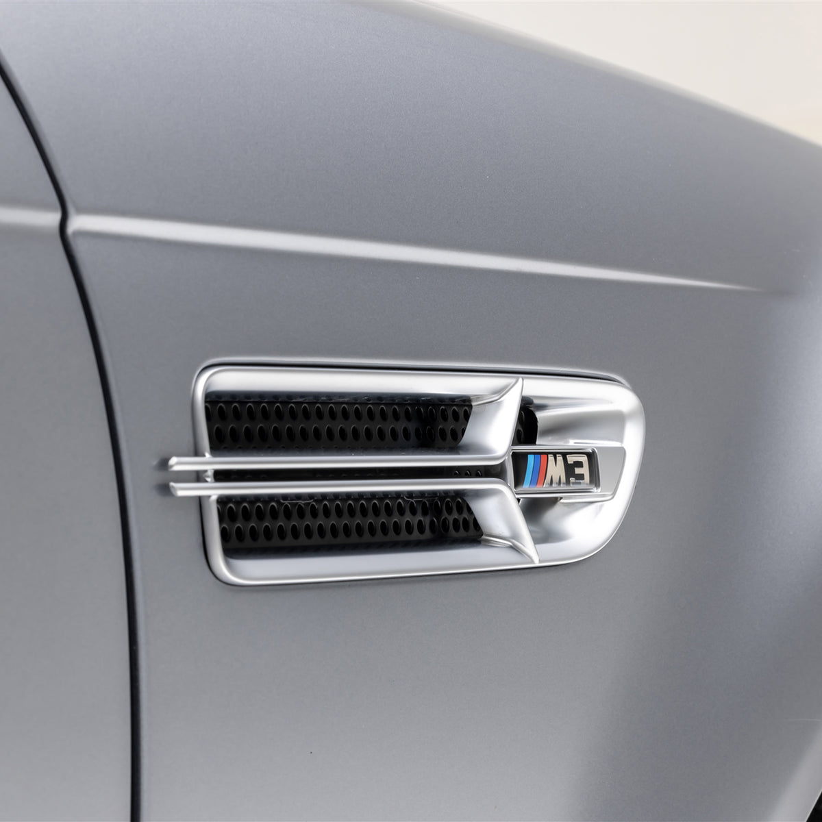 Nickel-plated Aero side grilles for 2000-2006 BMW E46 M3 V20 by Vorsteiner Aerodynamics, showing close-up of grille design.