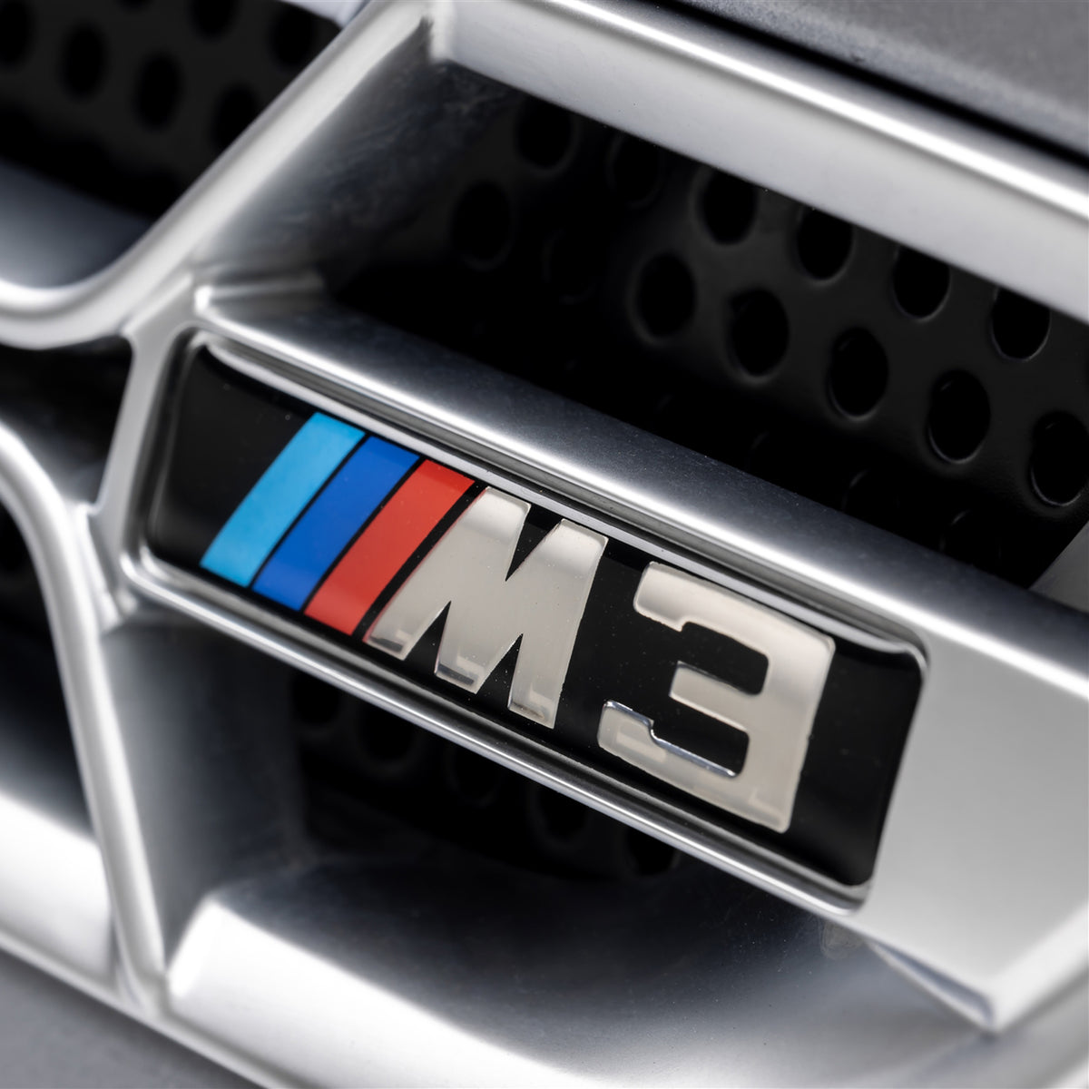 Nickel-plated Aero side grilles for BMW E46 M3 V20 Limited, designed by Vorsteiner Aerodynamics, installed on a silver car.