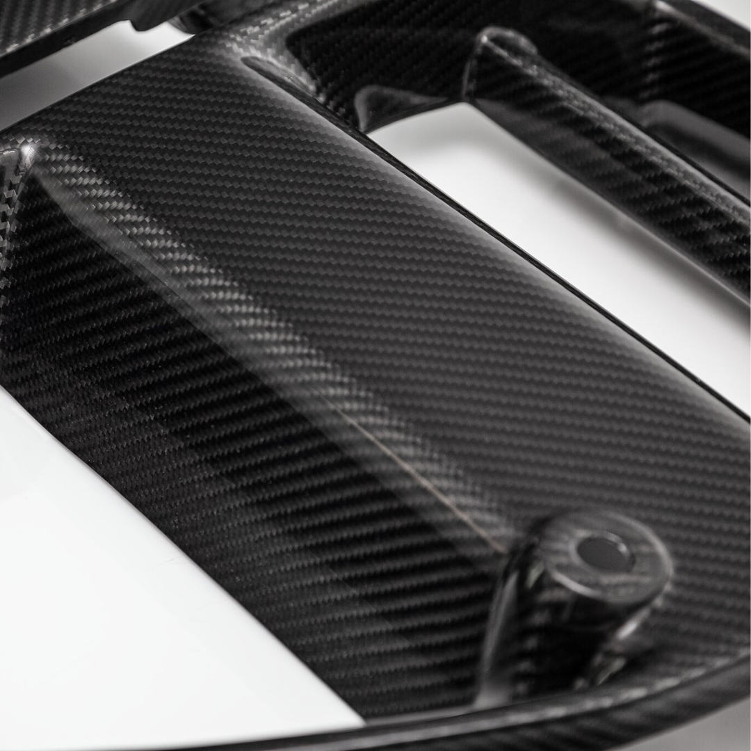 BMW G8X M3 and M4 Vorsteiner carbon fiber front V-style sport grille for enhanced aerodynamics and aggressive look.