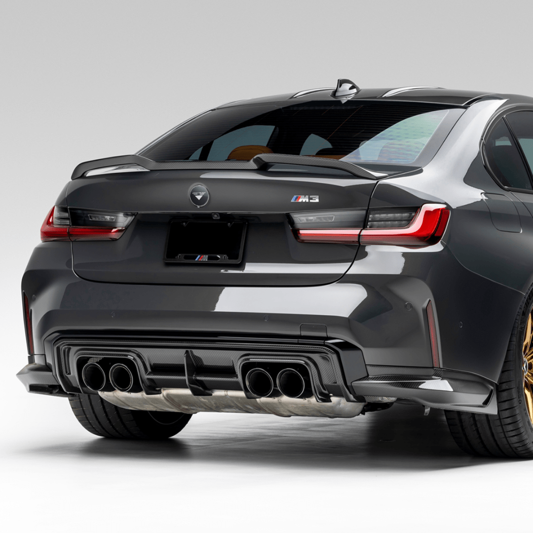 BMW G8X M3 carbon fiber rear diffuser V-Style Aero by Vorsteiner Aerodynamics, showcasing its sleek V-shaped design and textured finish.