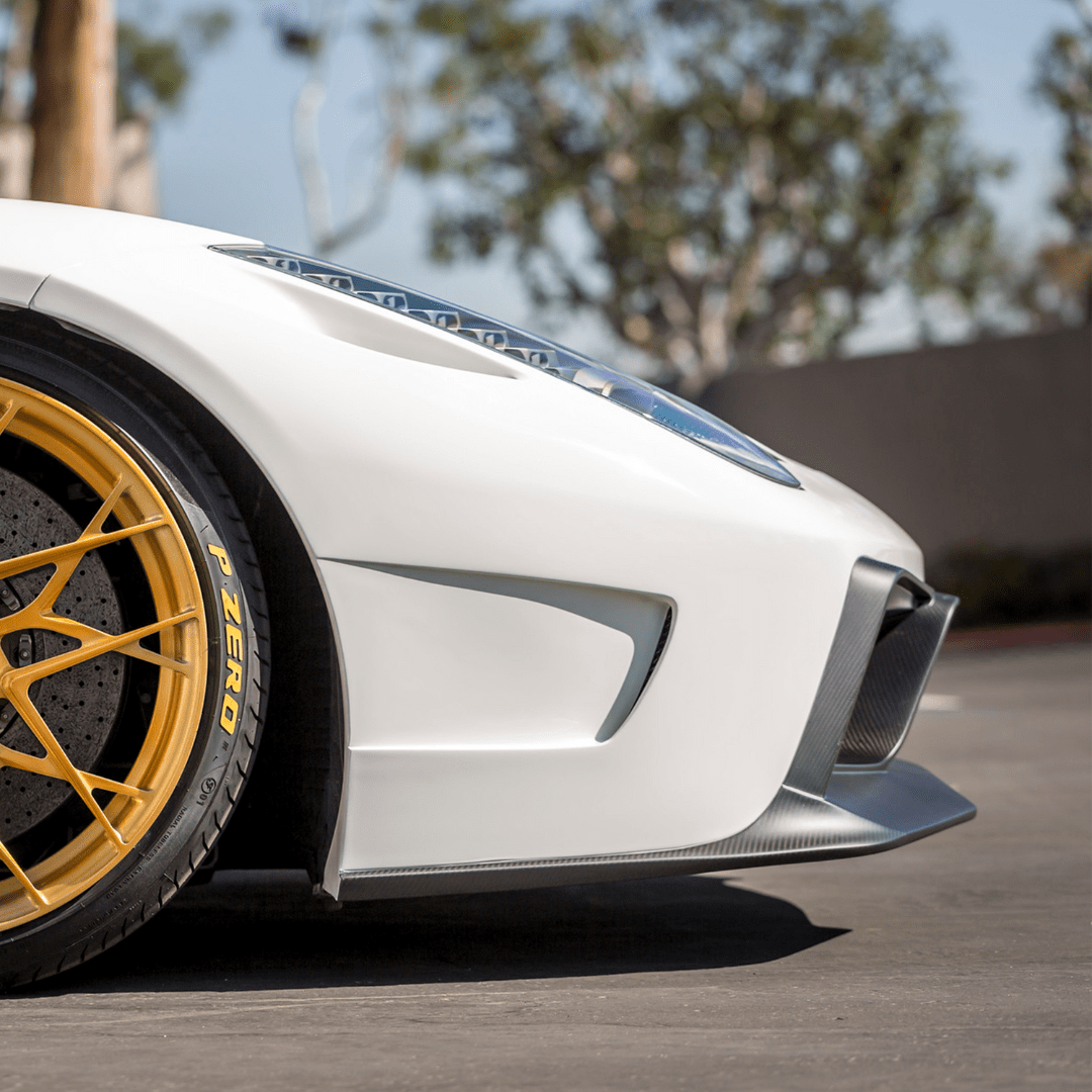 Vorsteiner Aerodynamics Ferrari 458 Italia VX carbon fiber front bumper with integrated front spoiler, showcasing sleek aerodynamic design.