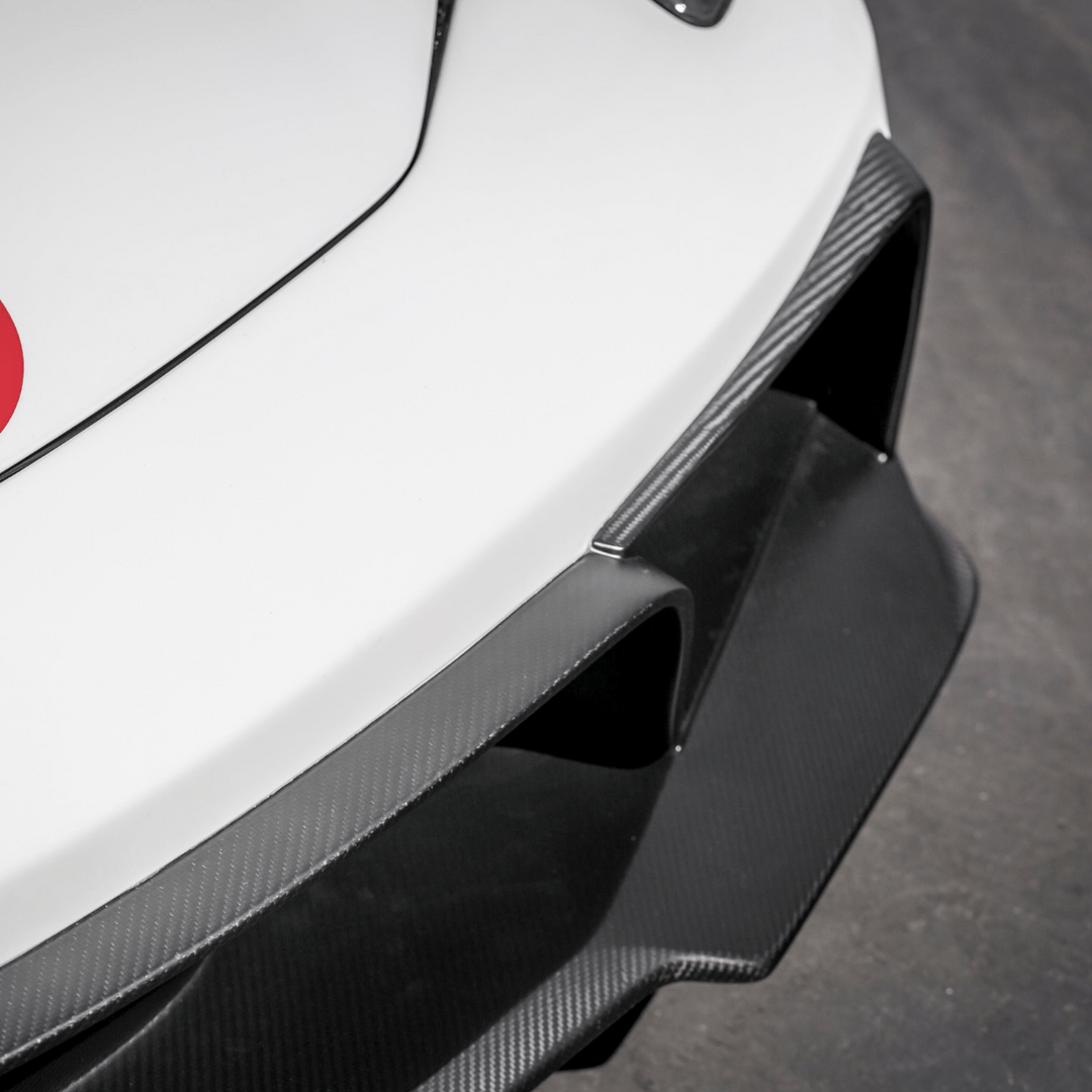Ferrari 458 Italia VX carbon fiber front bumper with aero front spoiler by Vorsteiner Aerodynamics, showing sleek front design and aerodynamics.