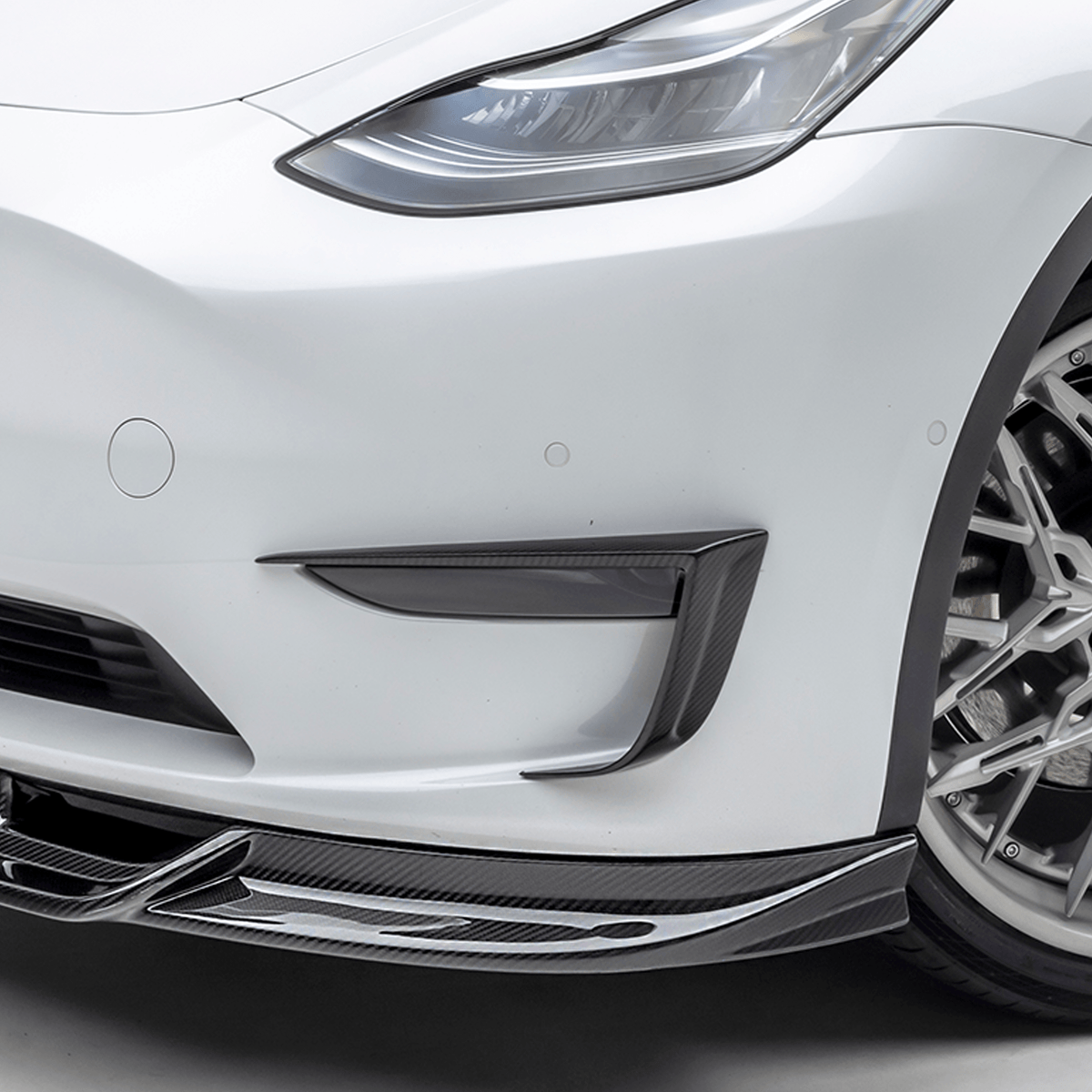 Tesla Model Y Aero Add-On Bumper Flares by Vorsteiner Aerodynamics, showing sleek, aerodynamic bumper flare extensions on the vehicle.
