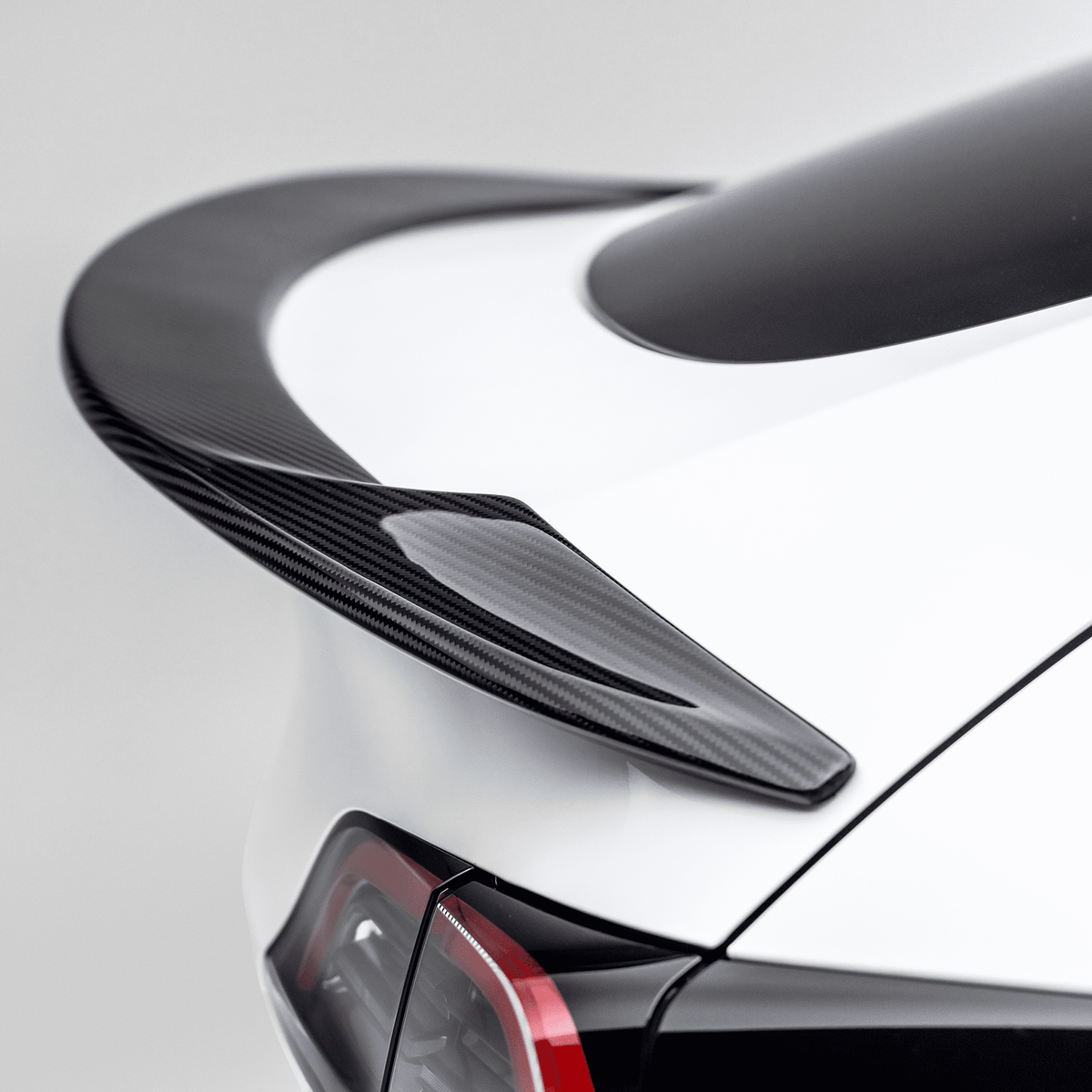 Tesla Model Y Aero Decklid Spoiler by Vorsteiner Aerodynamics, showing the sleek, aerodynamic design mounted on the vehicle's rear.