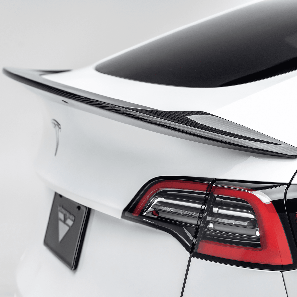 Vorsteiner Aerodynamics Tesla Model Y Aero Decklid Spoiler installed on the vehicle, showcasing sleek design and aerodynamic features.