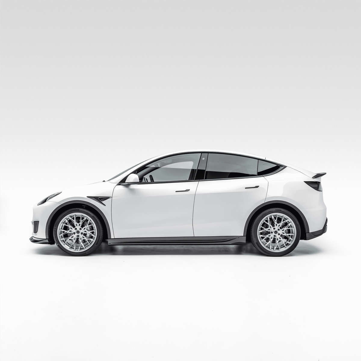 Tesla Model Y Aero Decklid Spoiler by Vorsteiner Aerodynamics, showing the sleek, aerodynamic design mounted on the vehicle's rear.