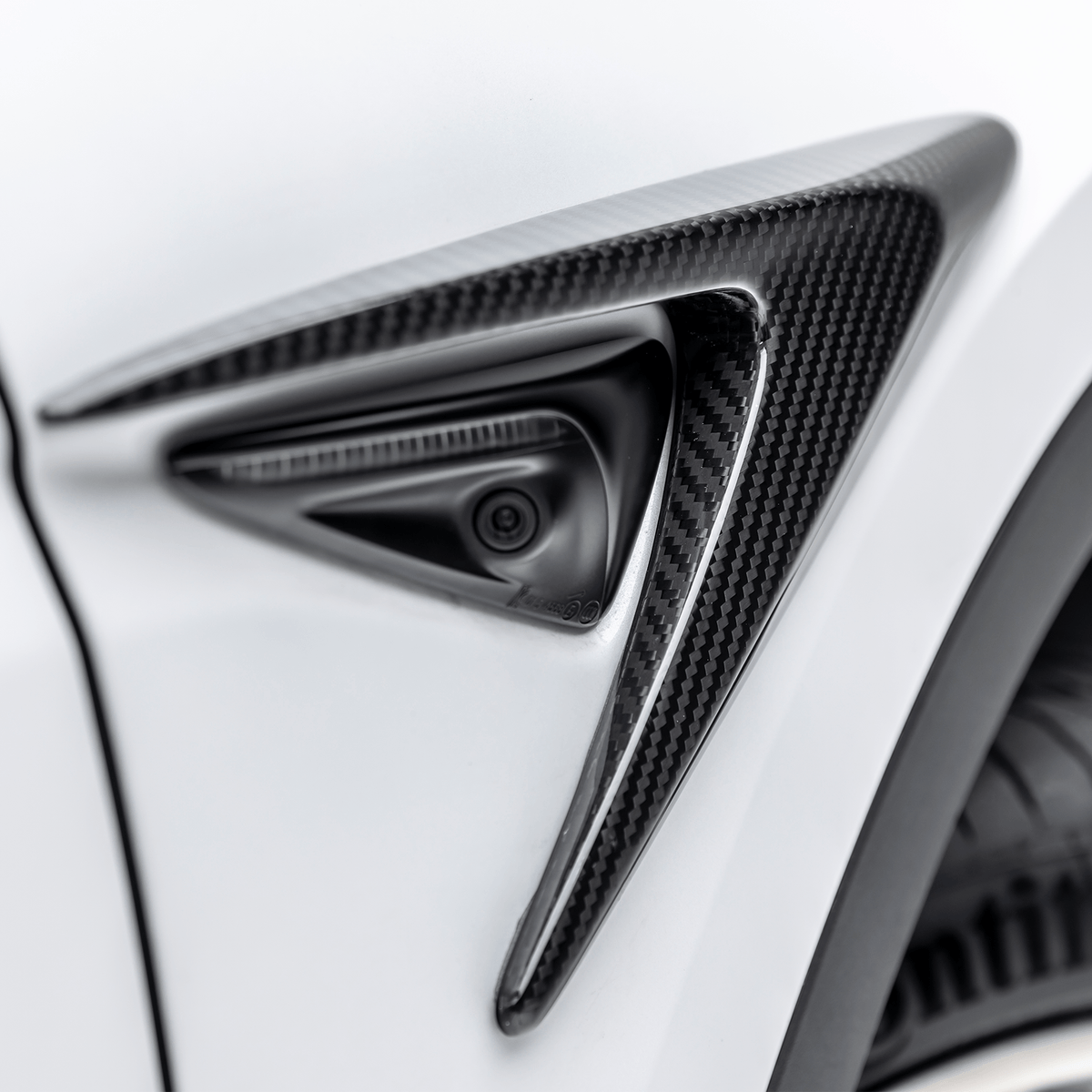 Tesla Model Y Aero Add-On Fender Vents by Vorsteiner Aerodynamics, showcasing sleek black vent design on car fender.