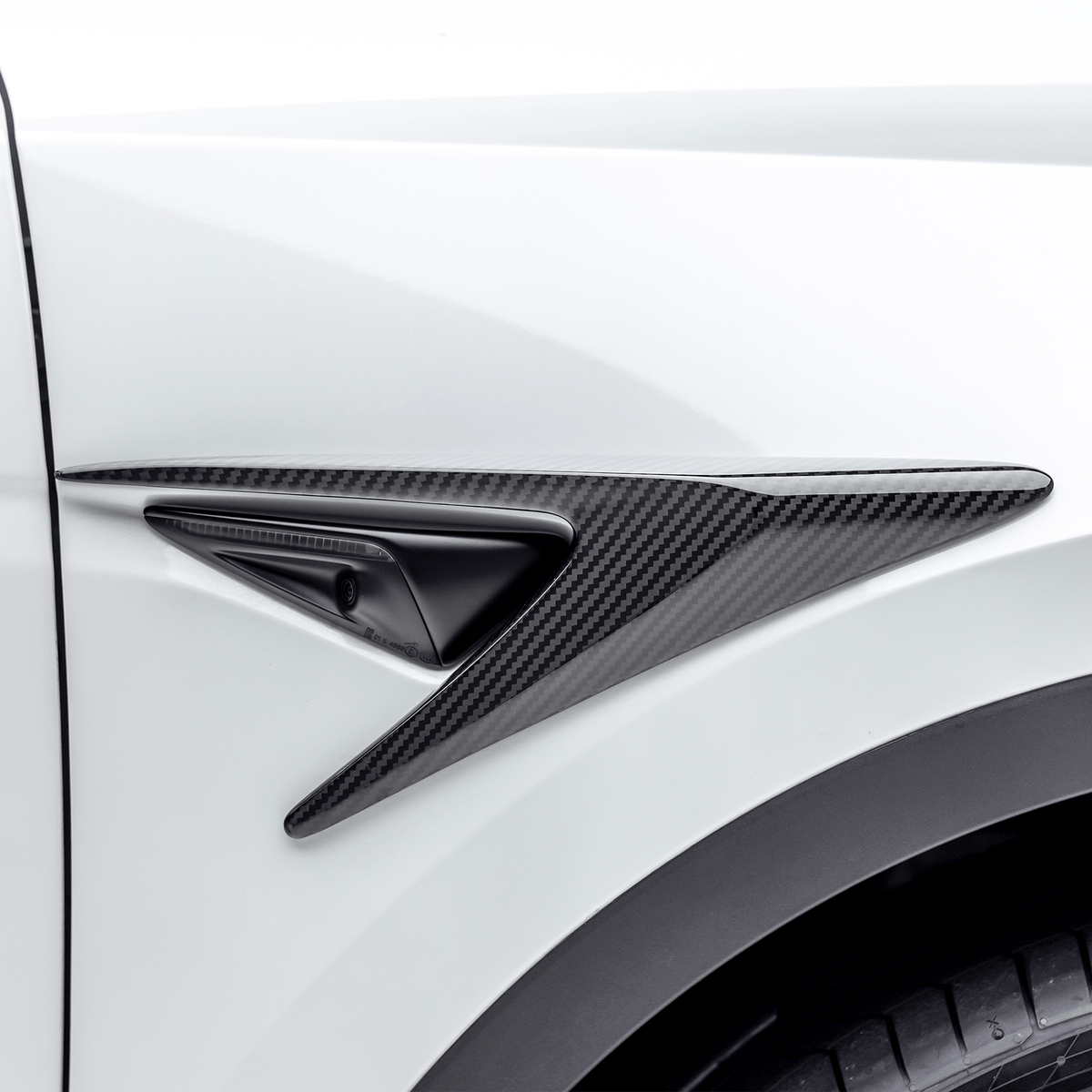 Tesla Model Y Aero Add-On Fender Vents by Vorsteiner Aerodynamics, showing sleek vent design on black car fender.