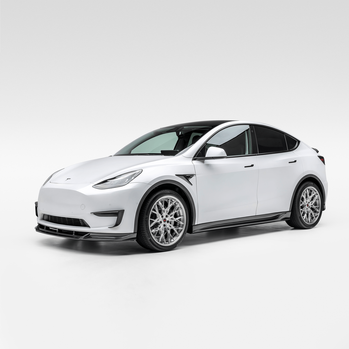 Vorsteiner Aerodynamics Tesla Model Y Aero Front Spoiler mounted on the vehicle, showcasing its sleek design and aerodynamic features.