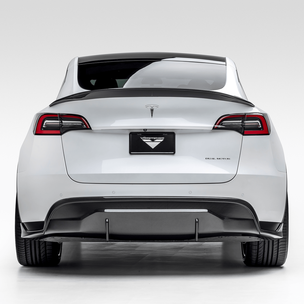 Tesla Model Y aero rear diffuser by Vorsteiner Aerodynamics, showing the sleek, aerodynamic design on the vehicle's rear underside.