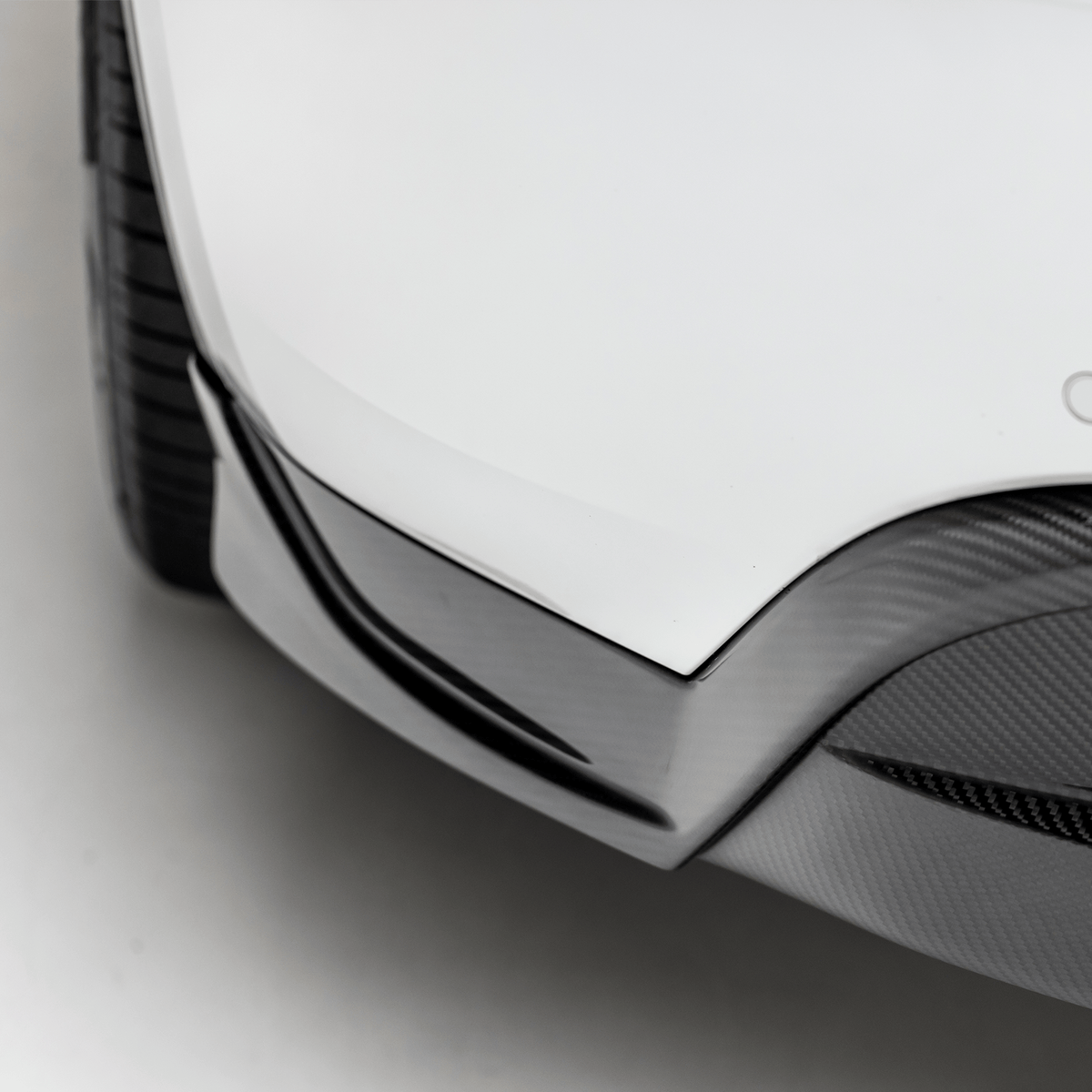 Tesla Model Y Aero rear diffuser by Vorsteiner Aerodynamics, showcasing sleek black aerodynamic component on the vehicle's rear.