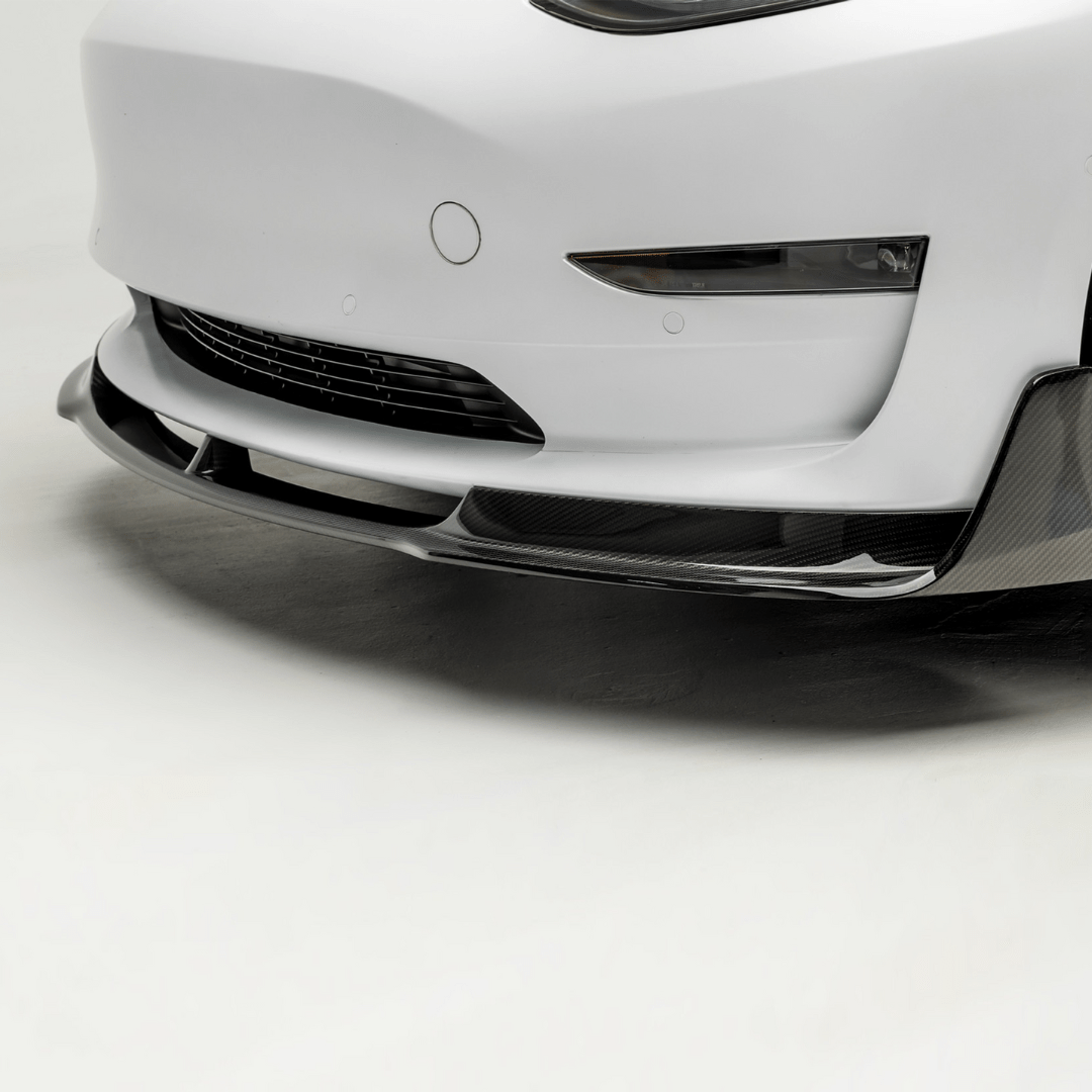 Tesla Model 3 Volta Aero front spoiler by Vorsteiner Aerodynamics, featuring carbon fiber design for enhanced aerodynamics and sporty look.