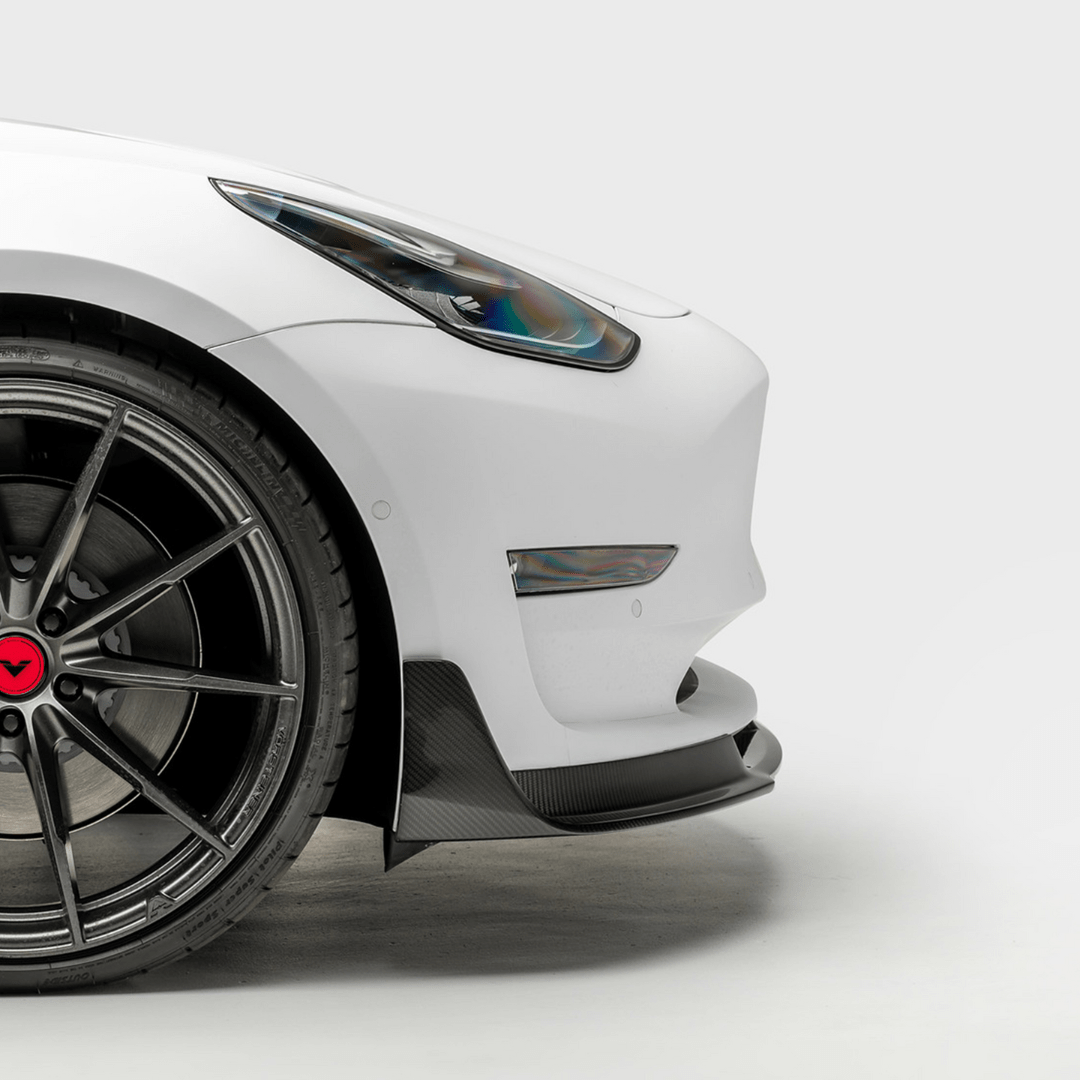 Tesla Model 3 Volta Aero front spoiler by Vorsteiner Aerodynamics, showcasing carbon fiber design and sleek aerodynamic features.
