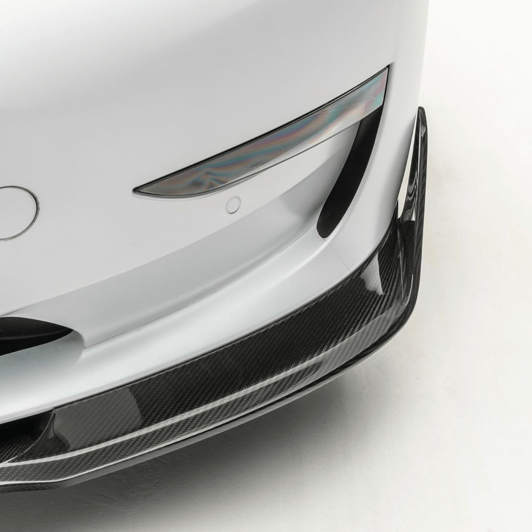 Vorsteiner Aerodynamics Tesla Model 3 Volta Aero front spoiler in carbon fiber with sleek, aerodynamic design.