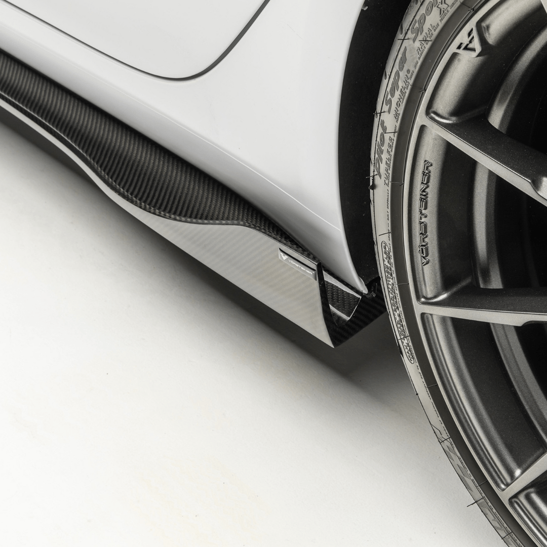 Carbon fiber Tesla Model 3 Volta Aero side skirt by Vorsteiner Aerodynamics, showcasing sleek, aerodynamic design on the car's side.