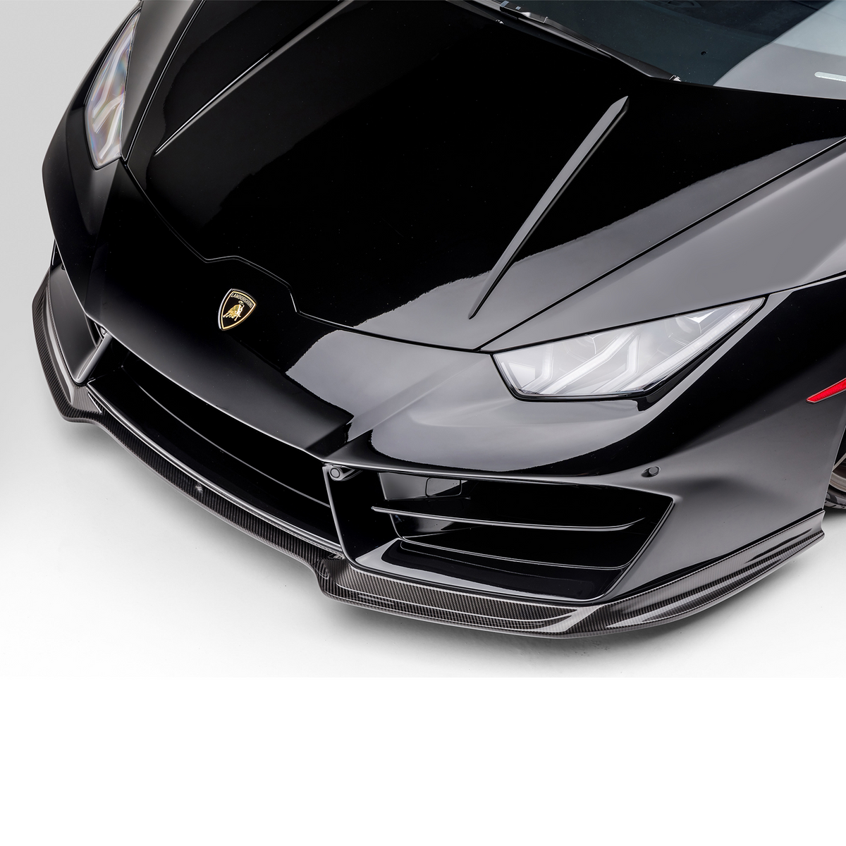Vorsteiner Lamborghini Huracan LP580 Monza Aero front spoiler in carbon fiber, showcasing sleek aerodynamic design.