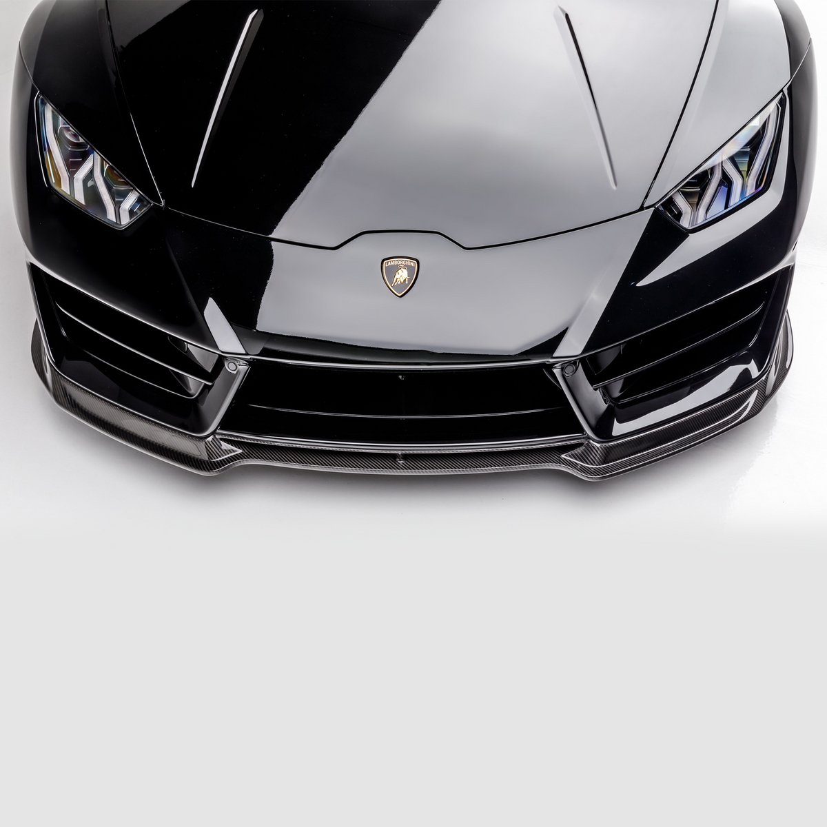 Vorsteiner Lamborghini Huracan LP580 Monza Aero front spoiler in carbon fiber, showcasing sleek aerodynamic design for high-performance sports cars.